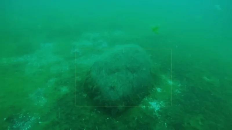 A submerged stone formation in Lake Michigan, resembling an underwater structure