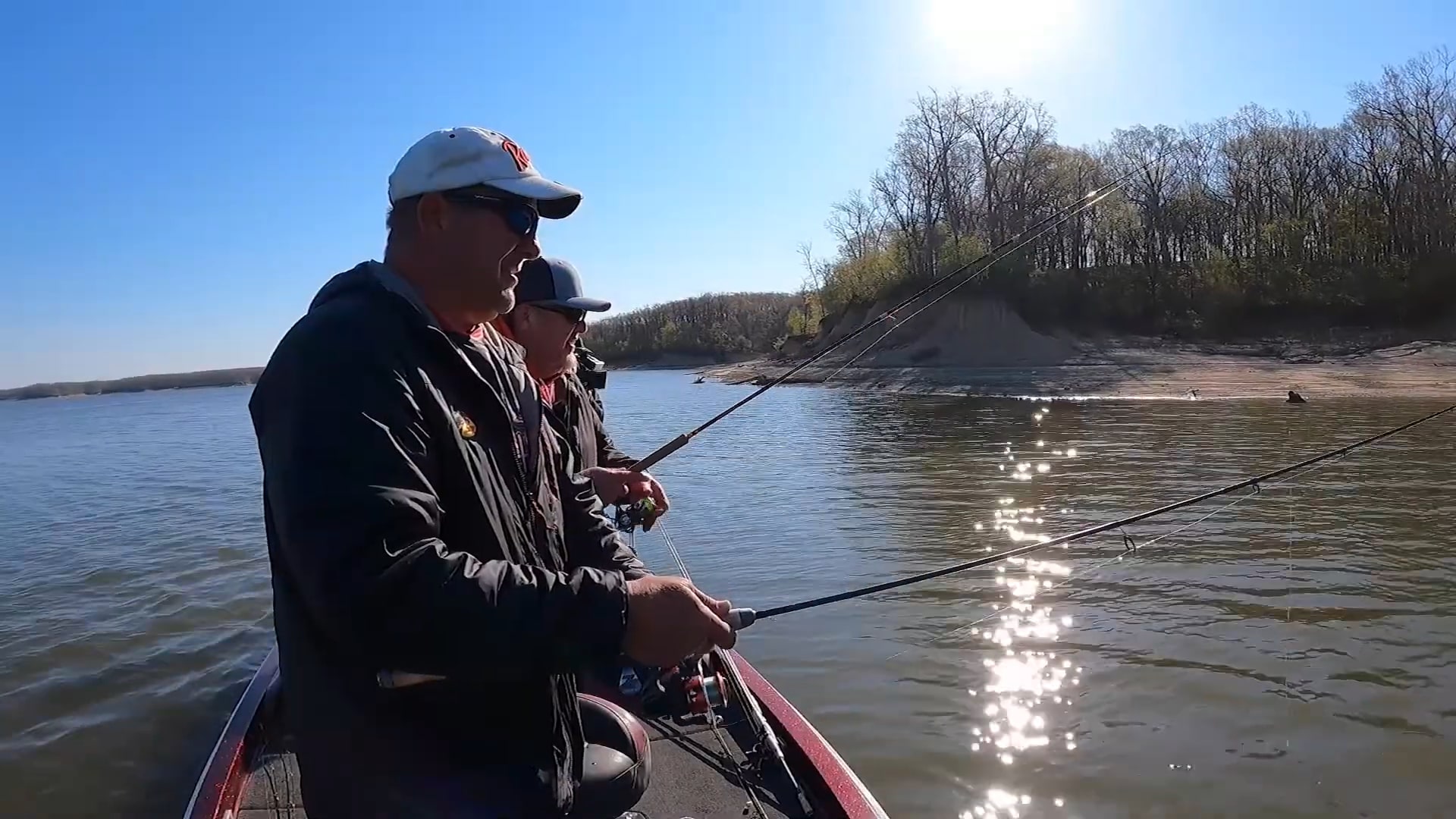 Two anglers fishing from a boat on a sunny day at Lake Shelbyville